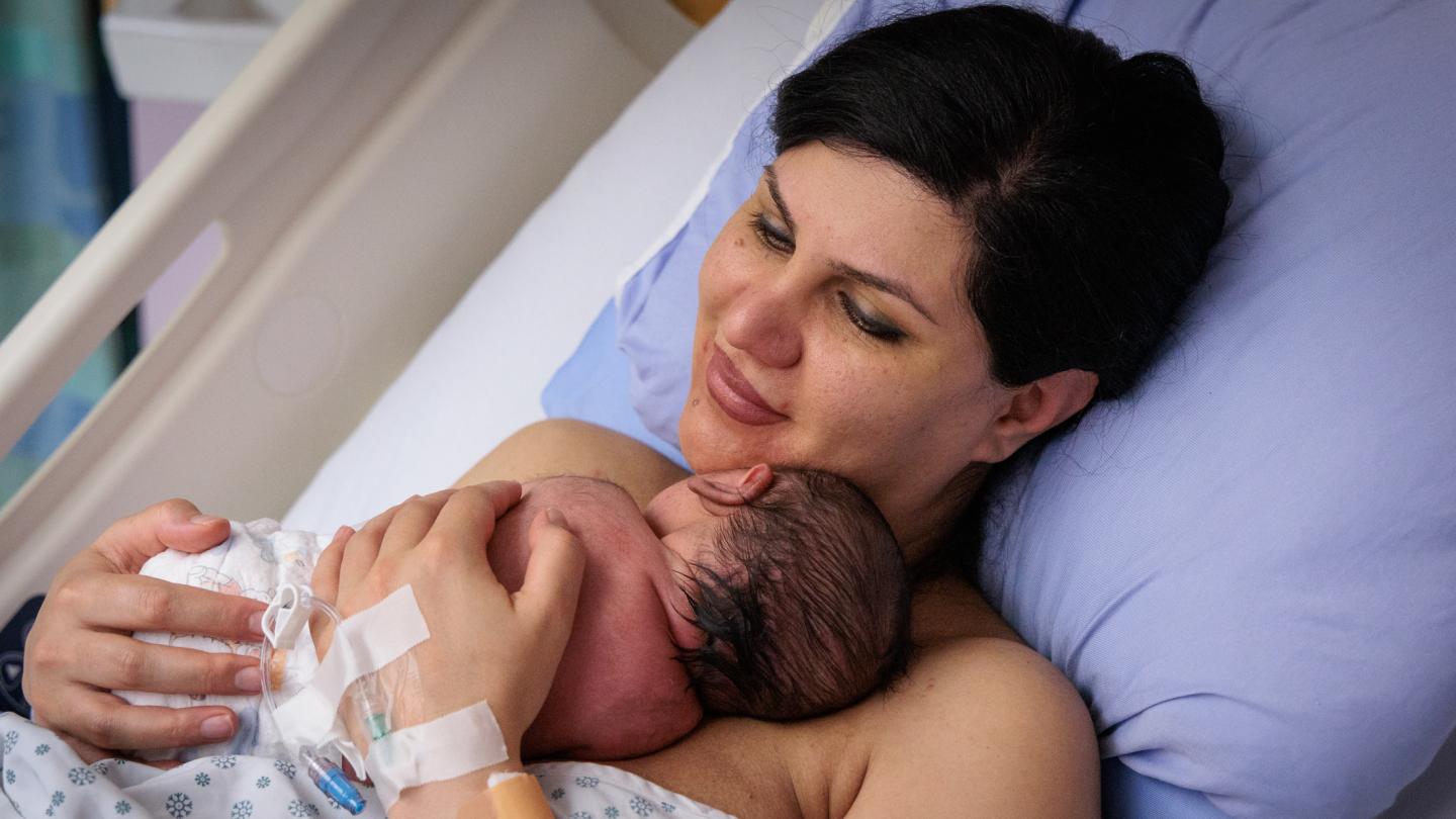 Newborn baby resting on their mother's chest