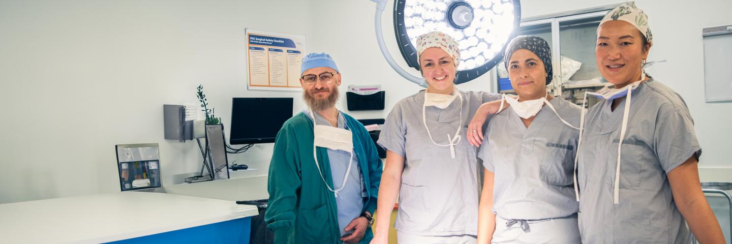 Surgeons and nurses smiling in an operating room