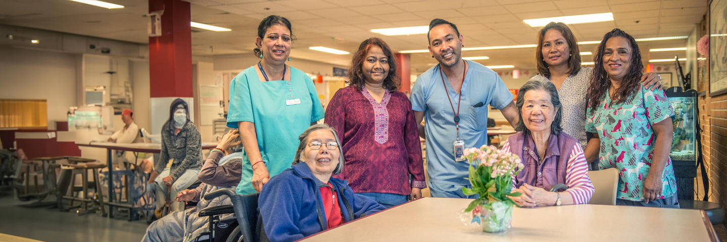 Nurses and tenants smiling in a long-term care home