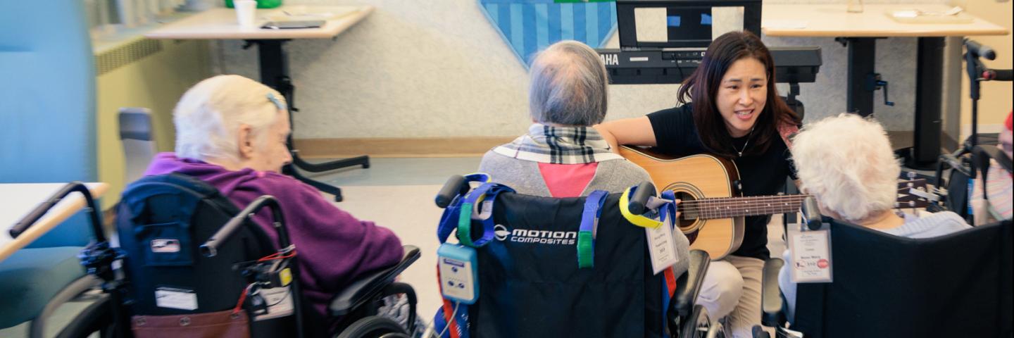 Music therapist strums her guitar and sings for tenants