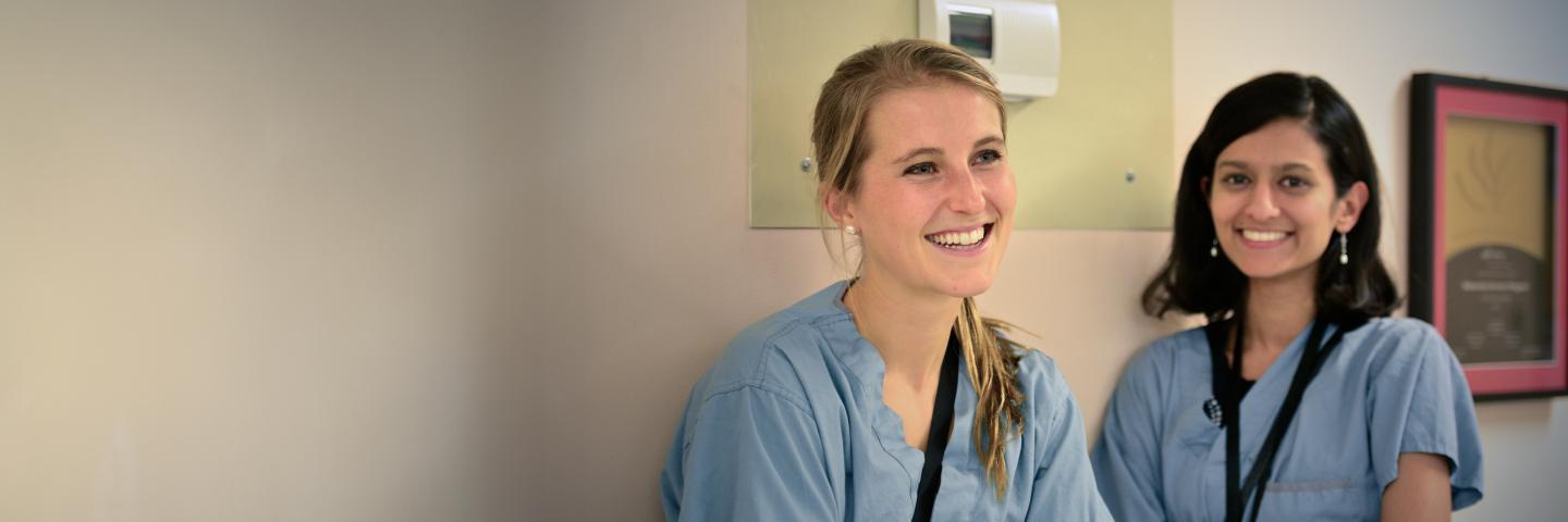 Two medical interns smiling