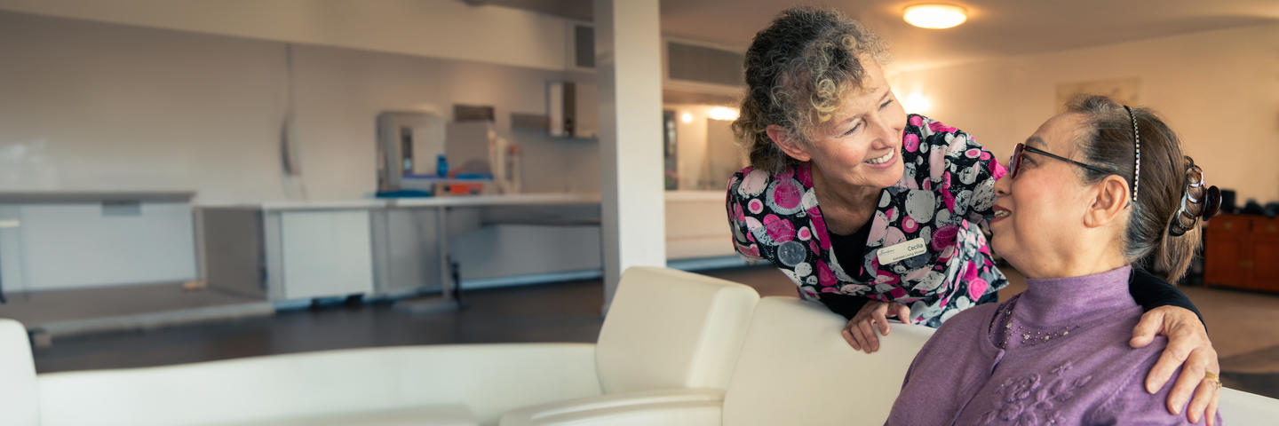 Nurse smiling and greeting a resident