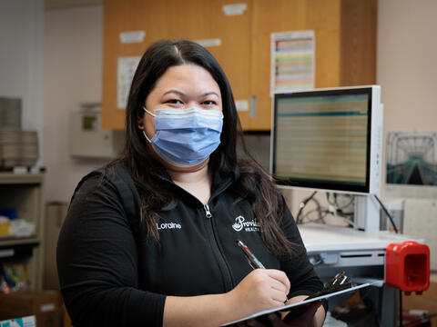 Nurse wearing mask charting