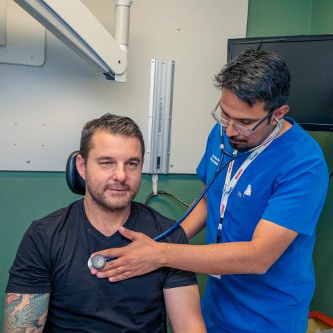 Doctor placing a stethoscope on a patient's chest